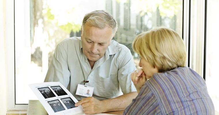 Ginekolog lub radiolog tłumaczy pacjentce wyniki bada USG.