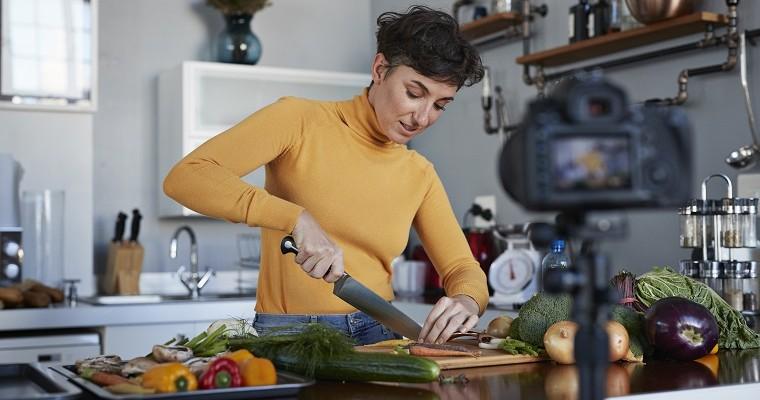 Kobieta kroi warzywa lub owoce na desce do krojenia w kuchni. Zdrowe odżywianie. 
