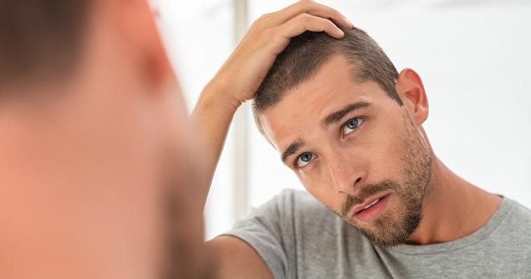 Mężczyzna, który sprawdza czy nie zaczyna łysieć 
